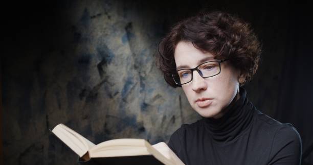 istock Mature woman is reading a paper book 1280322356