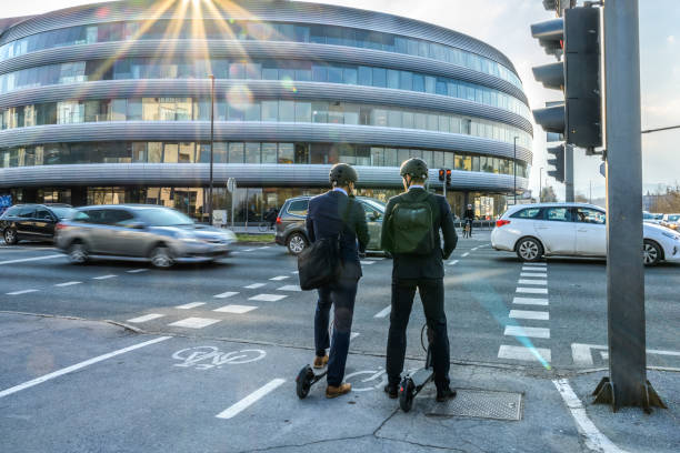 istock Businessmen waiting for traffic light with their e-scooter 1280322544