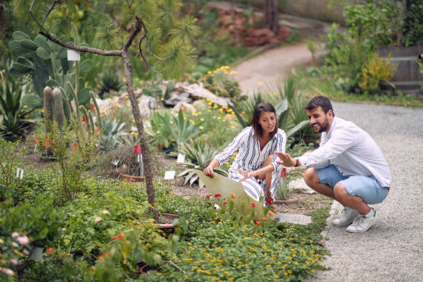 istock Male visitor and female guide studying the plants 1280323545