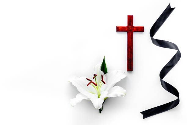 istock Funeral symbols. White lily with black ribbon, top view 1280323647