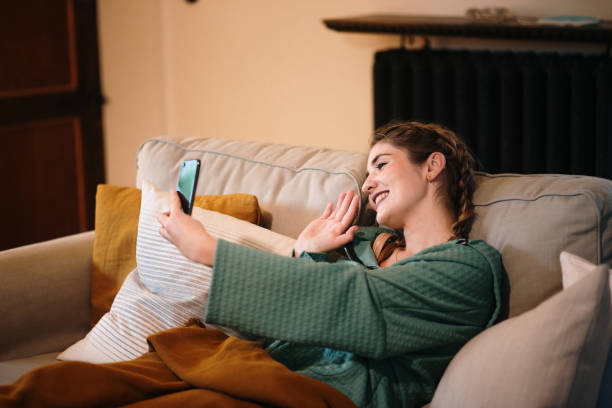 istock Young woman video calling with smart phone 1280325478