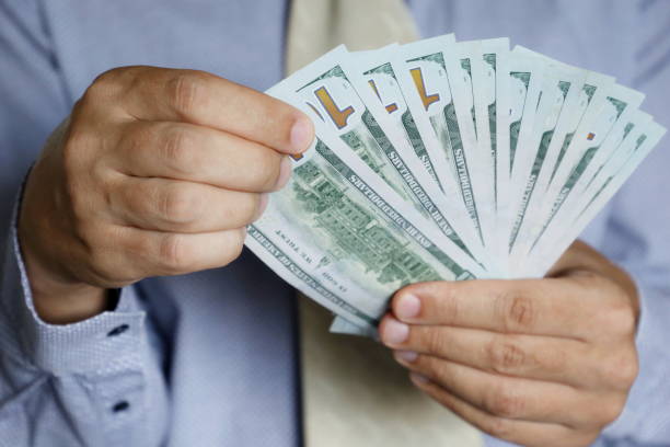 istock Man in business clothes with money 1280325649