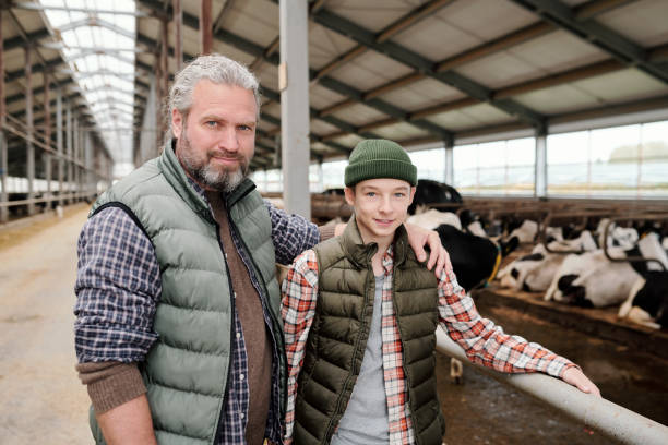 istock Male farmer and his son working together 1280326480