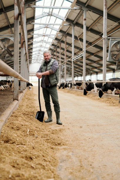 istock Handsome farmer with shovel 1280326505