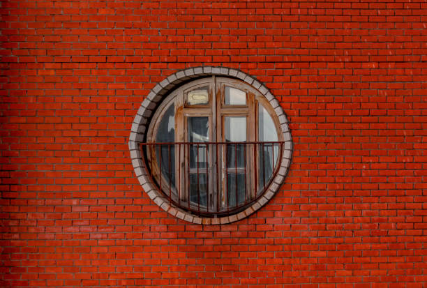 istock Vintage circle wooden window on a brick wall building 1280326871