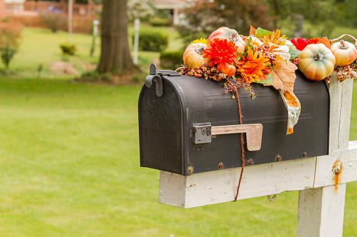 Mailbox decorated for Halloween. Halloween / Fall Decoration Adorns Beautiful Entry Way To Home. Front Porch decorated for the Halloween, Thanksgiving, Autumn season background. Thanksgiving Day.