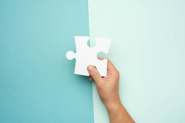 istock male hand holding big paper white blank puzzles on a blue background 1280328333