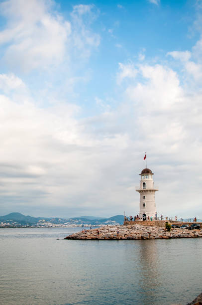 Alanya lighthouse, Turkey A lighthouse sits on the rocky shores of Alanya, Turkey lighthouse lighting equipment reflection rock stock pictures, royalty-free photos & images