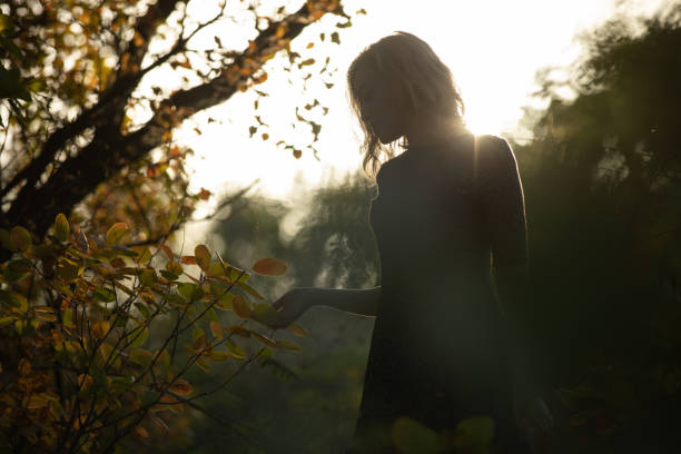 istock Happy woman silhouette in sunlight 1280332083