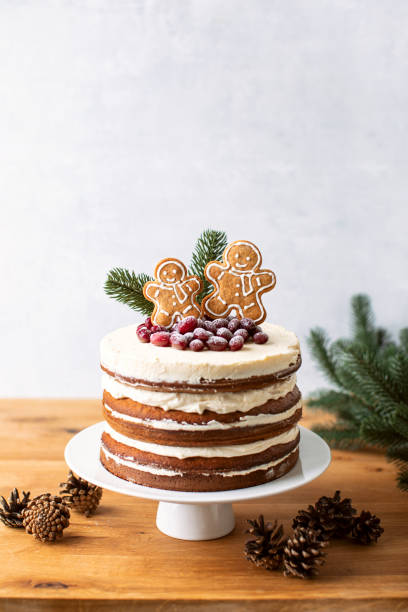 istock Naked cake decorated with gingerbread men and cranberries 1280332687