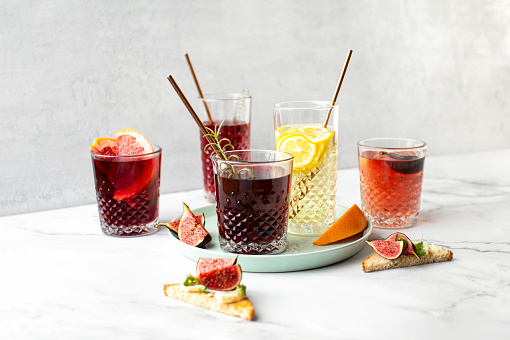 Front view of various sort of alcohol cocktails in a modern barware glasses