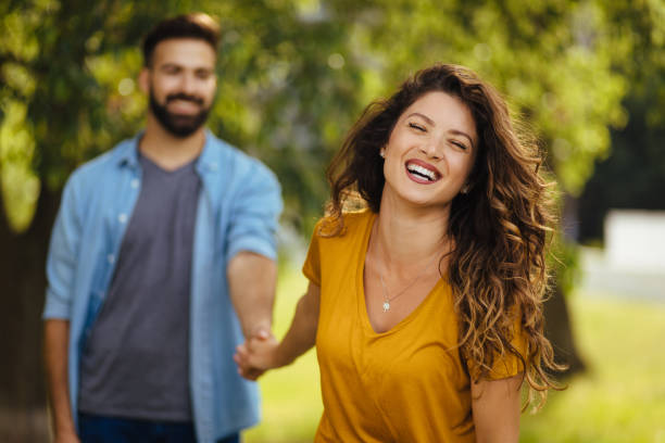 istock Young couple in love, taking a walk through the park holding hands 1280333162