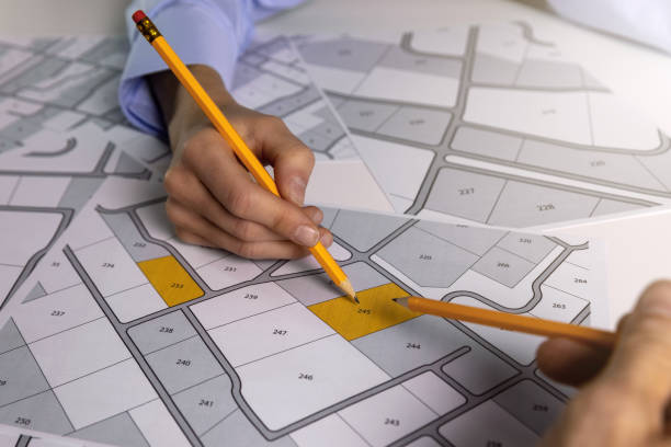 istock people discussing about territory building plots on cadastral map 1280334624