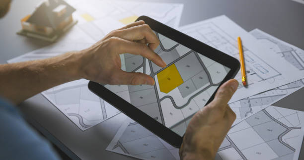 istock man searching building plot to buy on cadastral plan for house construction on digital tablet 1280334636