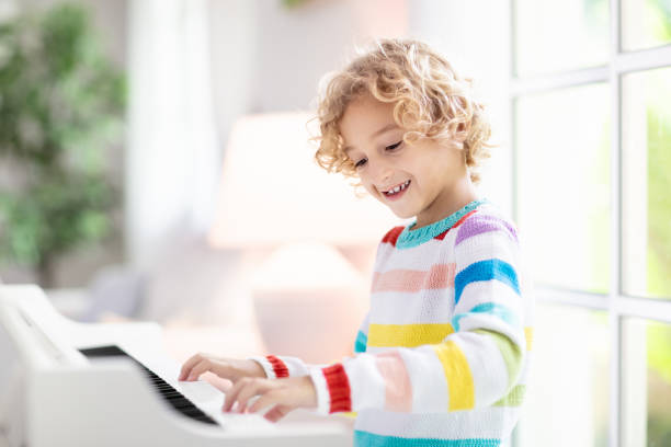 istock Child playing piano. Kids play music. 1280336693