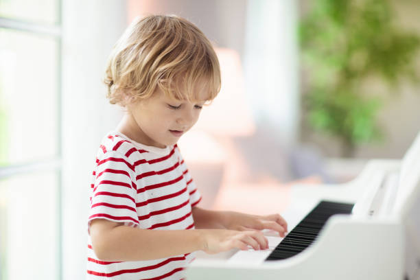 istock Child playing piano. Kids play music. 1280336713