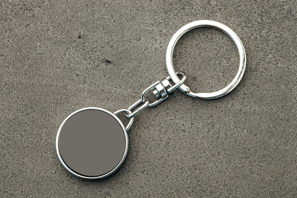 istock Metal key pendant on dark concrete background 1280336947
