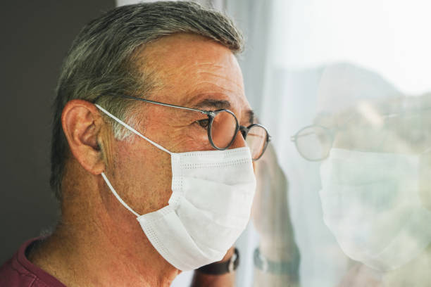 istock COVID-19, Mature man wearing disposable face mask 1280337513