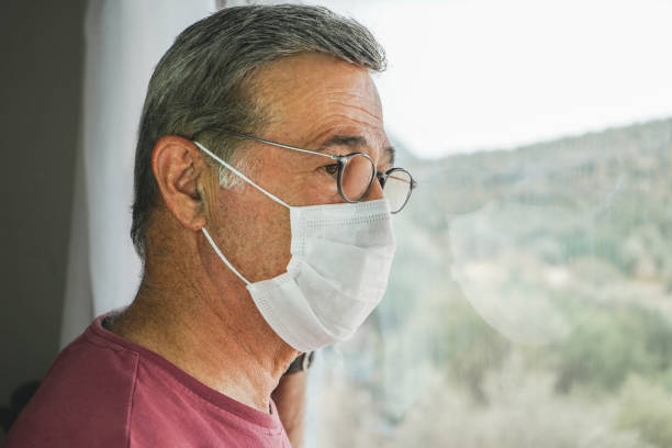 istock COVID-19, Mature man wearing disposable face mask 1280337586