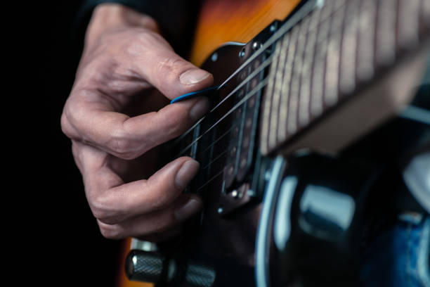 istock Guitarist hands and guitar strings close up. 1280337638