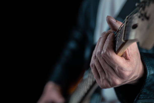 istock Guitarist hands and guitar strings close up. 1280337645