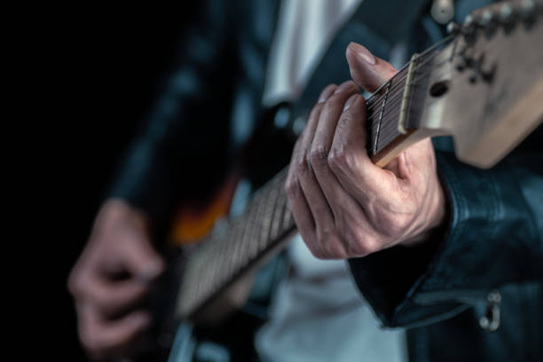 istock Guitarist hands and guitar strings close up. 1280337647