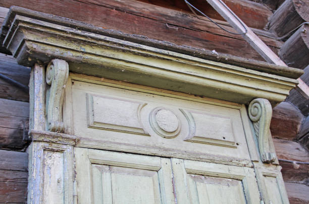 istock Old carved window with shutters on an old log house, close-up. 1280337744