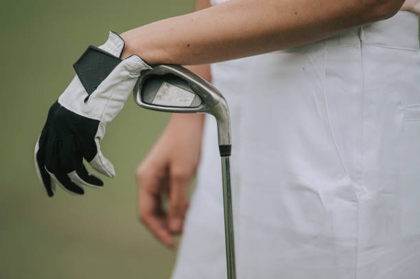 close up asian chinese female golfer's hamd on golf club close up asian chinese female golfer's hamd on golf club golf glove stock pictures, royalty-free photos & images