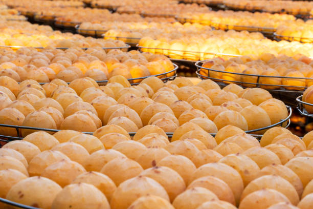 istock Making process of sun exposuring dried persimmon in a sieve in autumn. 1280338880