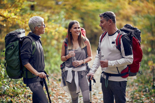 istock Friends in conversation at a break from hiking through 1280340711