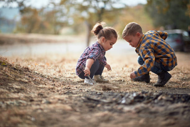 istock Kids digging the ground in the forest looking for a bugs 1280341073