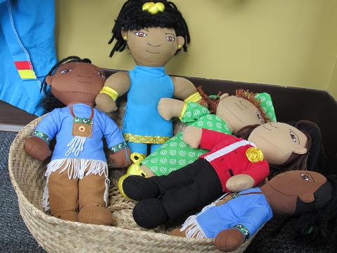 Dolls in a basket representing different nations.