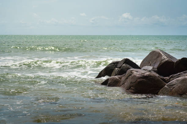 istock Seascape with black stone in sunny day. 1280342500