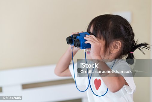 istock Happy Asian child enjoy looking through binoculars, Travel and adventure kid concept 1280342605