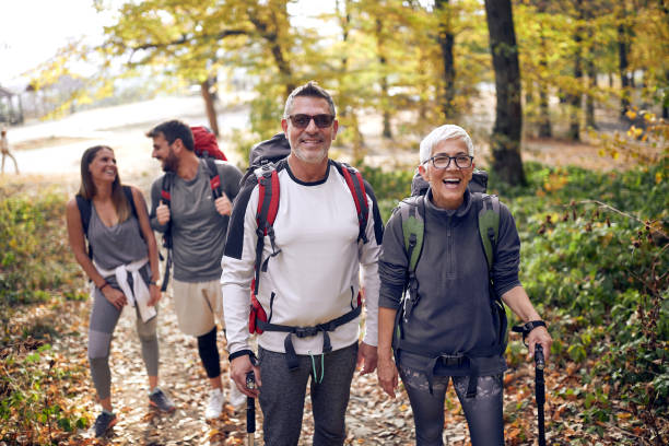 istock Couples enjoying the walk through the woods 1280343407
