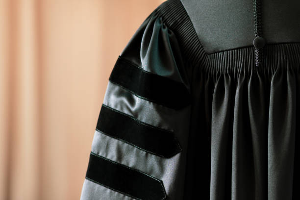 istock PhD graduate in black gown University degree 1280344560