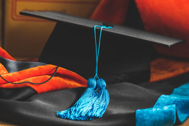 istock PhD graduate in black gown University degree 1280344566