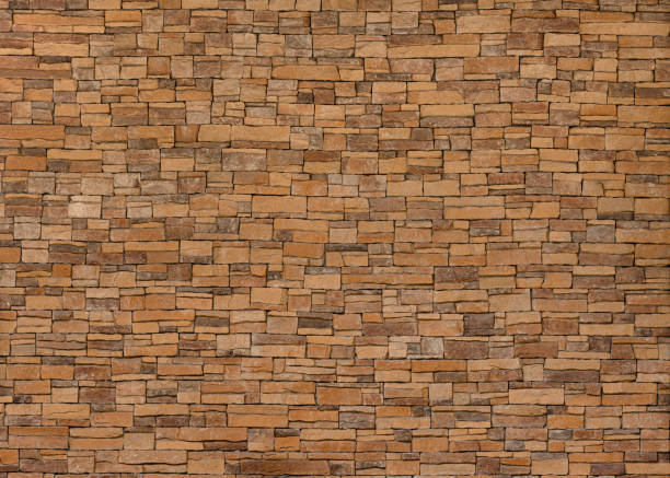 istock background and texture of yellow decorative stone wall surface. 1280344832