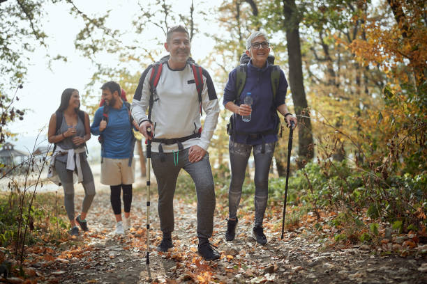 istock Couples hiking through the woods 1280345698