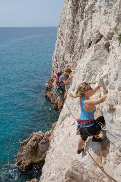 istock Brother and sister climb along coastal cliffs 1280346654