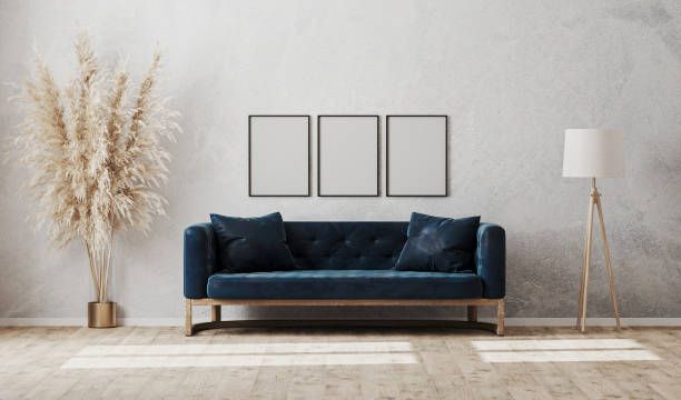 istock Blank vertical frames on gray decorative plaster wall in modern  living room interior with dark blue sofa, floor lamp, 3d rendering 1280348039