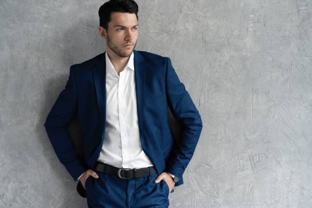 istock Handsome man wear blue suit isolated on grey background. 1280348125