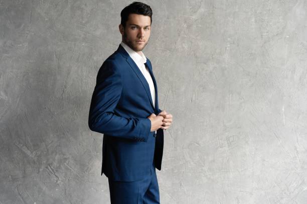 istock Handsome man wear blue suit isolated on grey background. 1280348127