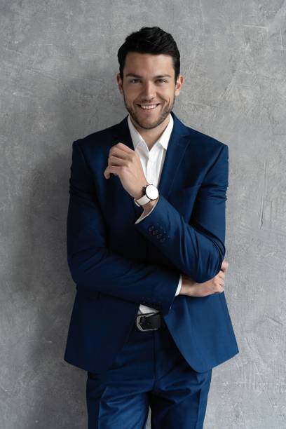 istock Handsome man wear blue suit isolated on grey background. 1280348139