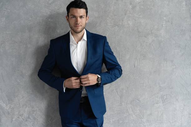 istock Handsome man wear blue suit isolated on grey background. 1280348164