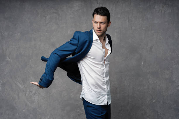 istock Handsome man wear blue suit isolated on grey background. 1280348166