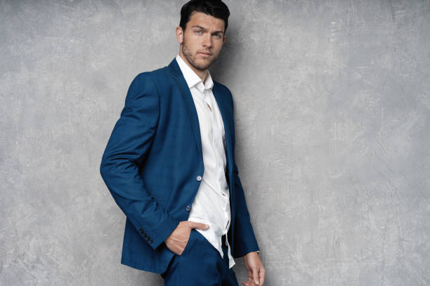 istock Handsome man wear blue suit isolated on grey background. 1280348175
