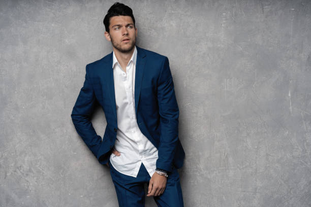 istock Handsome man wear blue suit isolated on grey background. 1280348177