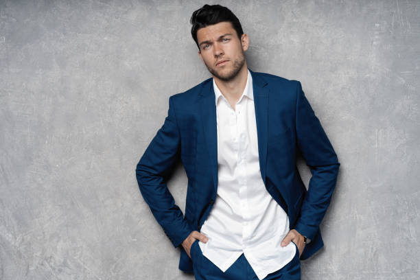 istock Handsome man wear blue suit isolated on grey background. 1280348178