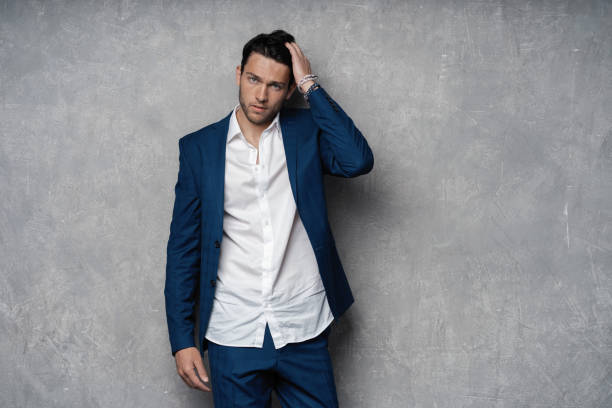 istock Handsome man wear blue suit isolated on grey background. 1280348180